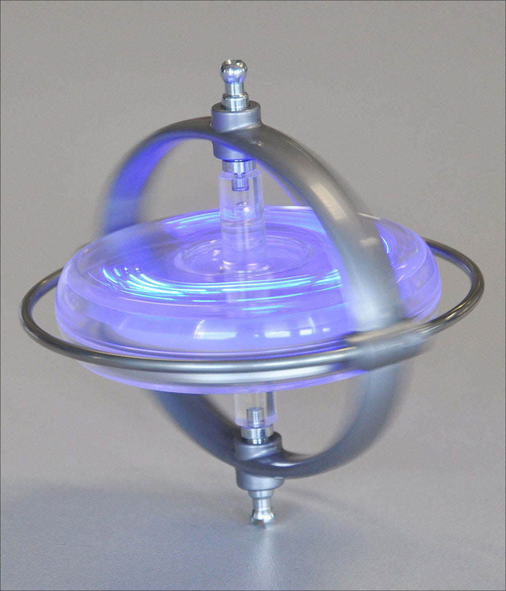 Kleines Gerät mit Metallrahmen, blauer LED-Beleuchtung, auf einer glatten Oberfläche.