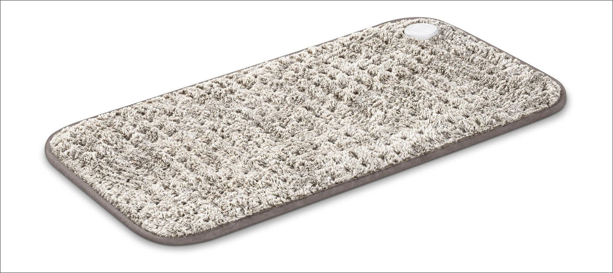 Waschbarer, rutschfester Badteppich mit grauem Rand und runder Antirutschmatte in einer Ecke.