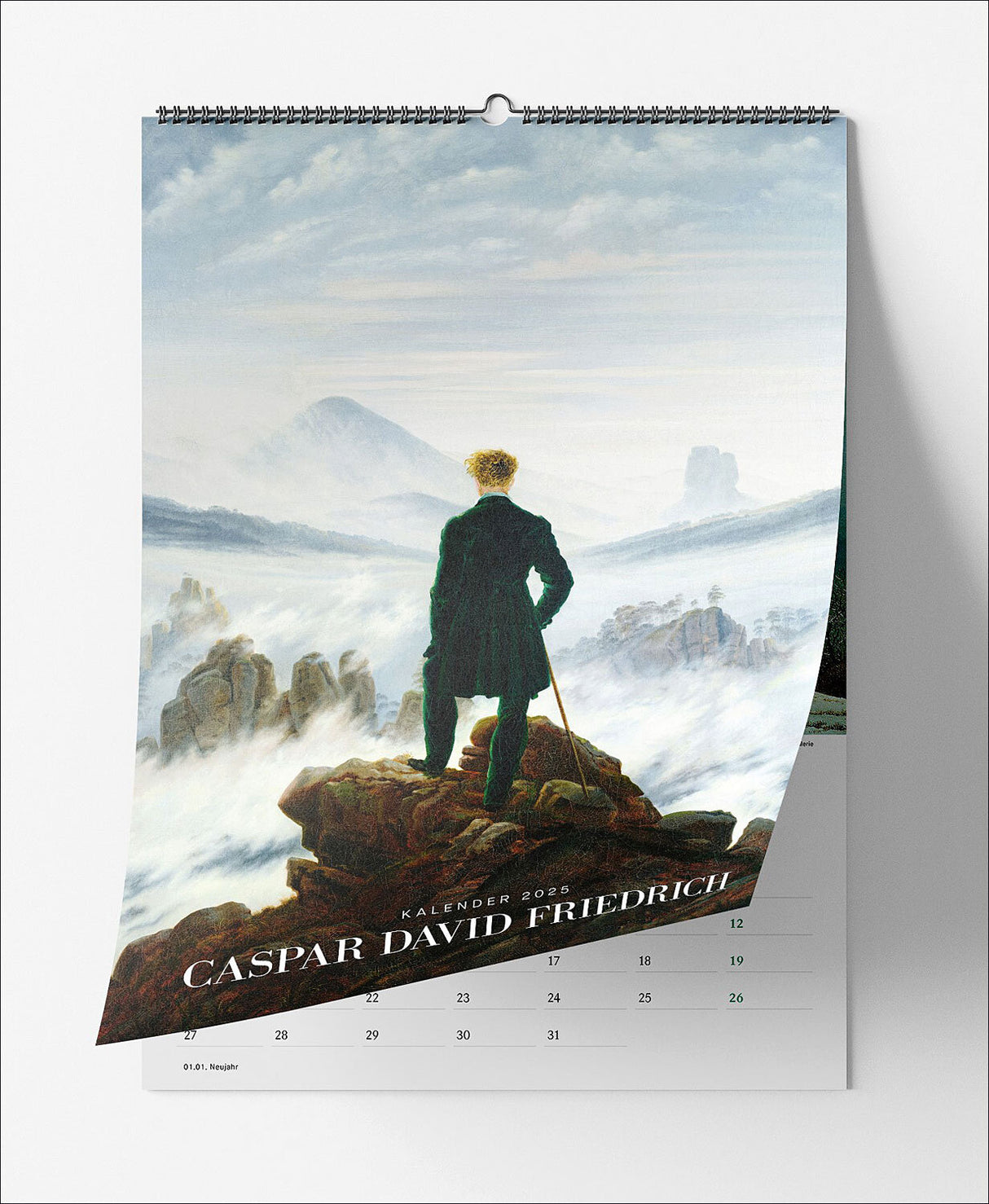 Kalenderblatt mit einer Person in einem schwarzen Mantel auf einem Felsen, Blick auf nebelverhangene Berge.