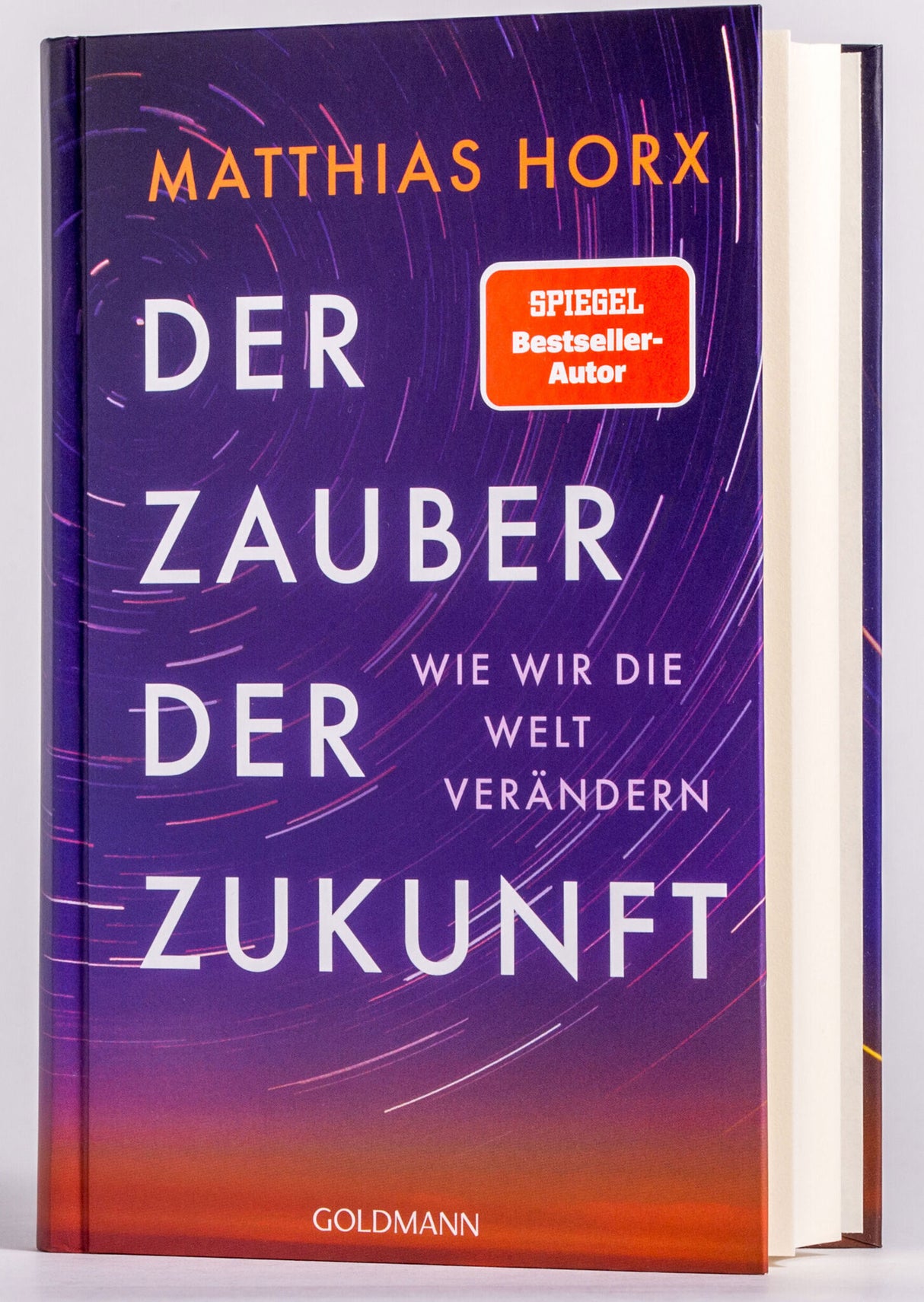 Buch mit lila, orange und rot Farbverlauf, Titel "Der Zauber der Zukunft" und Autor Matthias Horx.