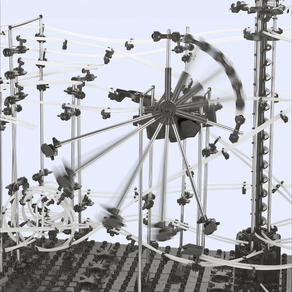 Kreisförmige, bewegliche Struktur mit mehreren Metallarmen, Kabeln und Verbindungsstücken, auf einer schwarzen Basis.