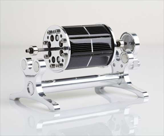 Drehmaschine mit schwarzem, zylindrischem Rotor und metallischen Endstücken auf einer weißen Oberfläche.