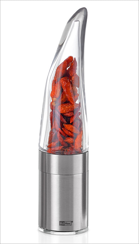 Elektrischer Gewürzmühle mit getrockneten roten Chilischoten im transparenten oberen Behälter.