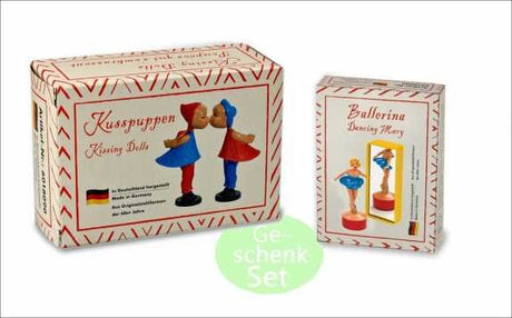 Zwei Puppen-Set: Kussenden Doll und Ballerina Dancing Mary, in Verpackungen mit deutschem Text und roten Mustern.