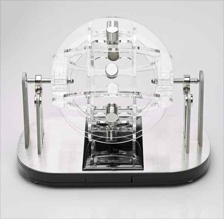 Präzises mechanisches Modell mit transparenten und metallischen Komponenten auf schwarzem Basis.