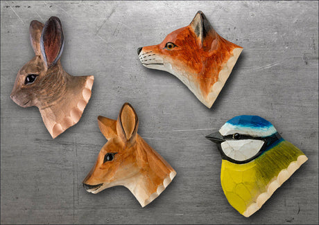 Vier handbemalte Holzmasken in Tierkopf-Form: Hase, Fuchs, Reh und Vogel.