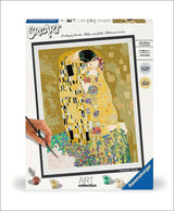 Puzzle-Set mit Gustav Klimts "Der Kuss" in Gold- und Silbertönen, mit Pinsel und Farbkästchen.