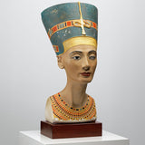 Statue eines ägyptischen Pharao-Kopfes mit kunstvoller Kopfbedeckung und Halskette auf Holzsockel.