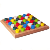 Holzbrett mit bunten, runden Spielsteinen in verschiedenen Farben.